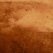Brown distressed textured surface with uneven darker patches (grunge wall texture).